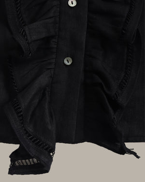 Close-up of a black blouse on a beige background