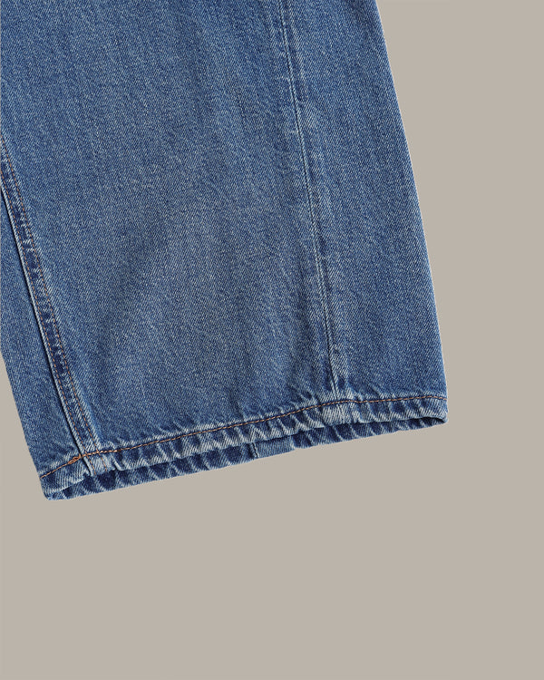 Close-up of blue denim fabric on a gray background